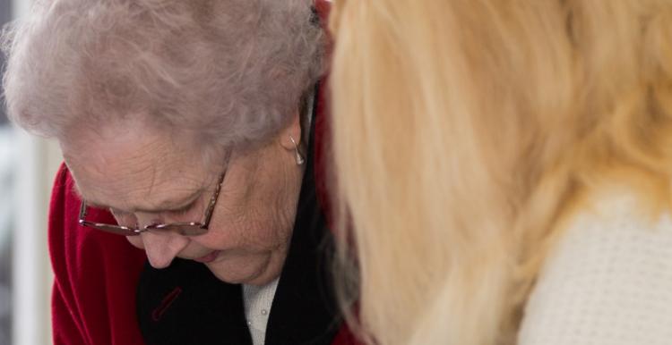 Older lady with a woman helping her