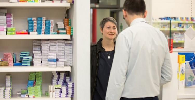 Person speaking to a pharmacist