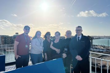 6 people standing on ferry