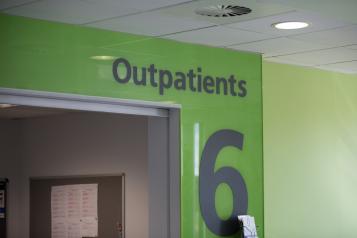 Sign in hospital corridor that says outpatients