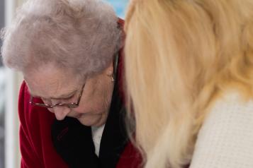 Older lady with a woman helping her