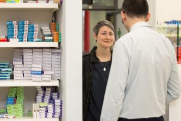 Person speaking to a pharmacist