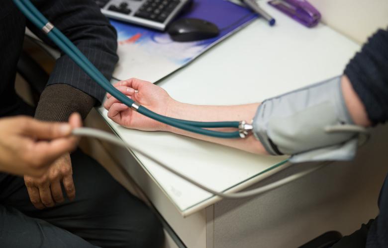 Patient having their blood pressure taken by their GP